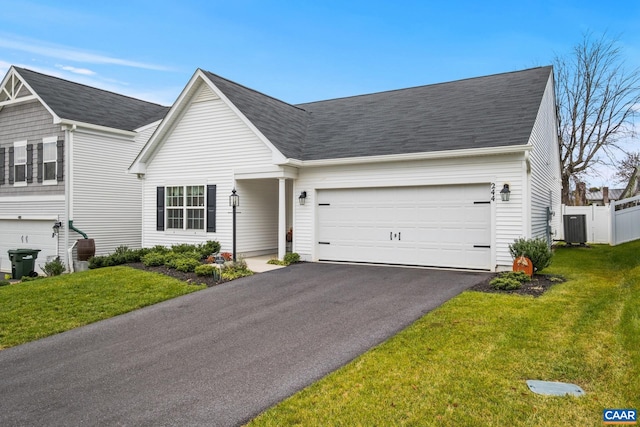 ranch-style house with central AC, a garage, and a front lawn