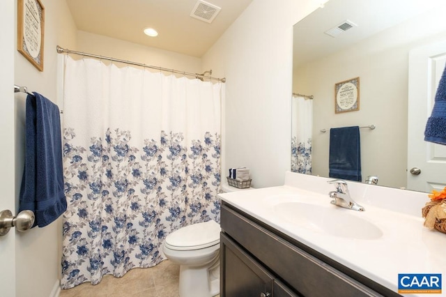 bathroom with tile patterned flooring, vanity, and toilet