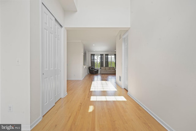 hallway with light hardwood / wood-style floors