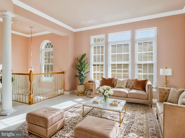 living room with decorative columns and ornamental molding