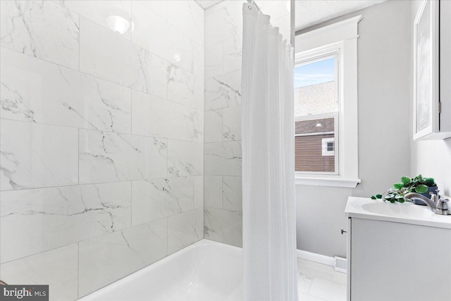 bathroom featuring tile patterned flooring, shower / bath combo, and vanity