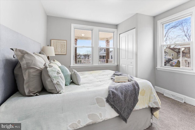 carpeted bedroom featuring a closet