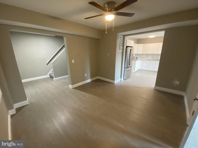 spare room featuring ceiling fan and light hardwood / wood-style flooring