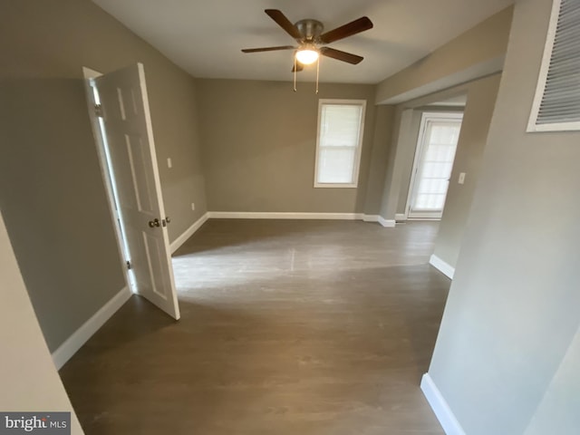 spare room with dark hardwood / wood-style floors and ceiling fan