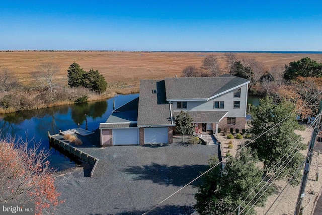 drone / aerial view with a rural view and a water view