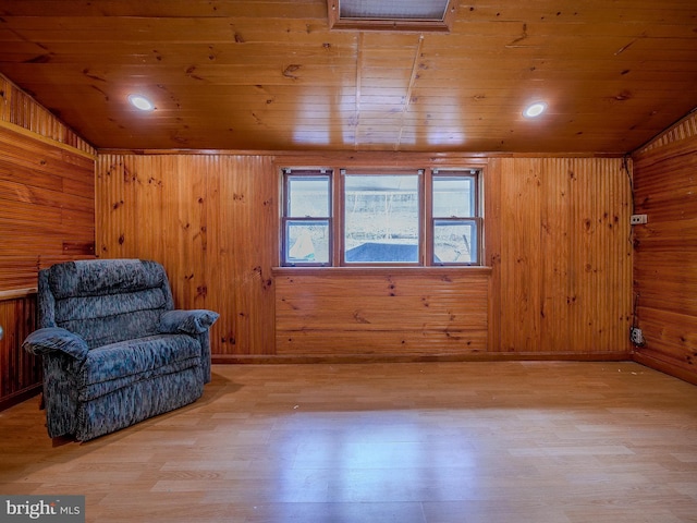 unfurnished room featuring wood walls, wood ceiling, light wood-type flooring, lofted ceiling, and recessed lighting