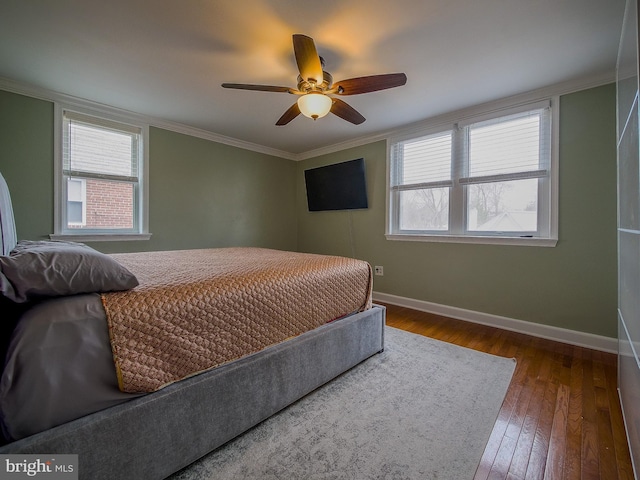 bedroom featuring ornamental molding, multiple windows, baseboards, and dark wood-style flooring