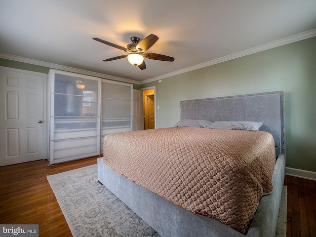 bedroom featuring crown molding, wood finished floors, baseboards, and ceiling fan