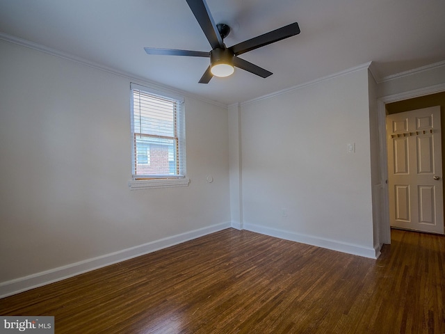 spare room with crown molding, wood finished floors, baseboards, and ceiling fan