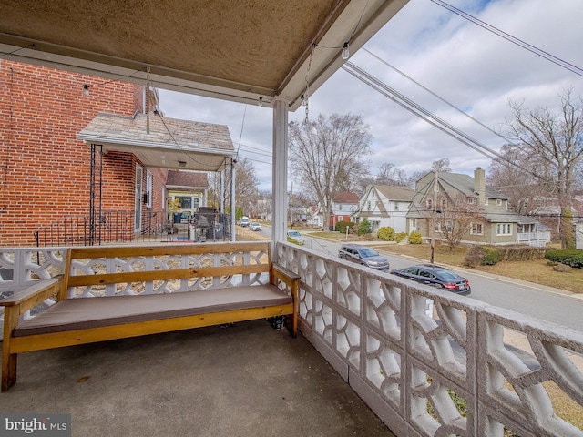 balcony with covered porch and a residential view