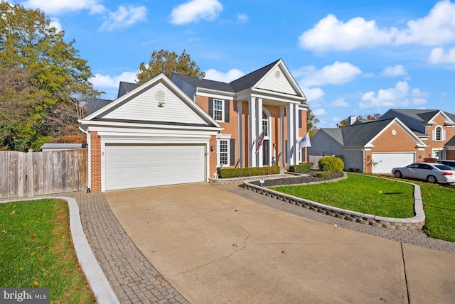 view of front facade with a front yard and a garage