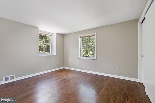 interior space with dark wood-type flooring and a healthy amount of sunlight