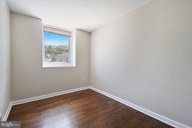 unfurnished room with dark hardwood / wood-style floors