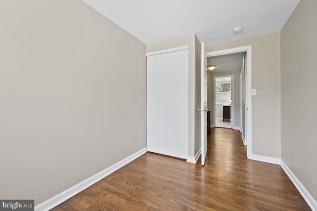 corridor with dark hardwood / wood-style floors