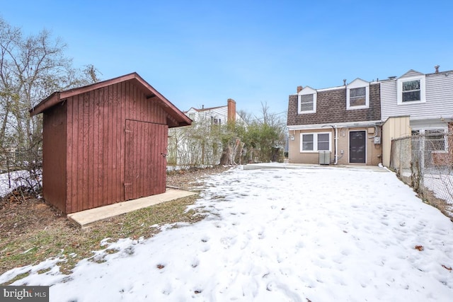 yard covered in snow featuring central AC