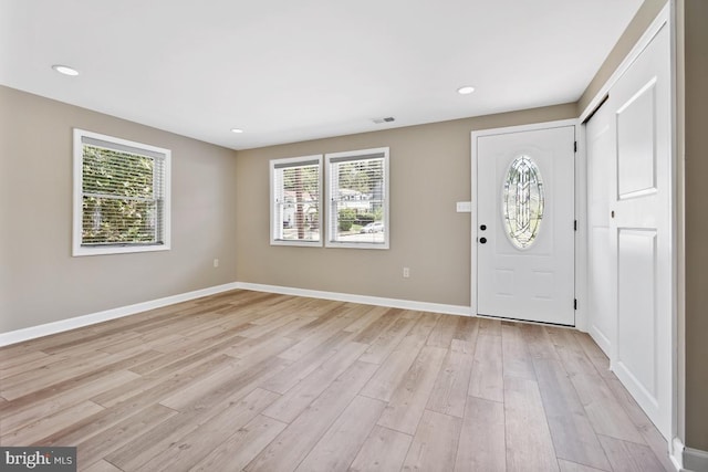 foyer entrance with light hardwood / wood-style floors