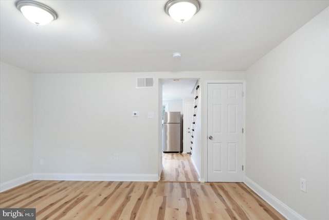 spare room with light wood-type flooring