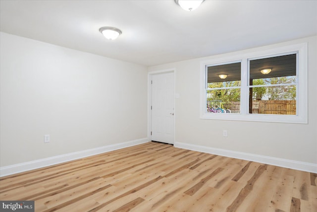 unfurnished room with light wood-type flooring