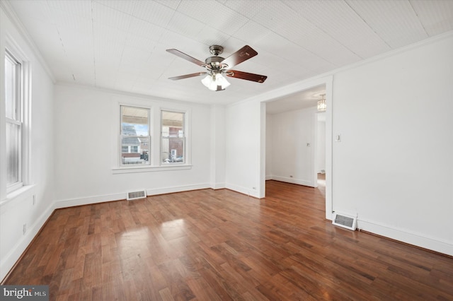 empty room featuring wood-type flooring, ceiling fan, and crown molding