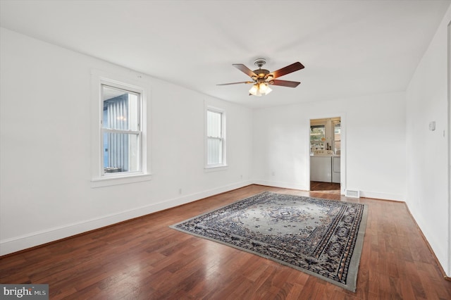 empty room with ceiling fan and dark hardwood / wood-style floors