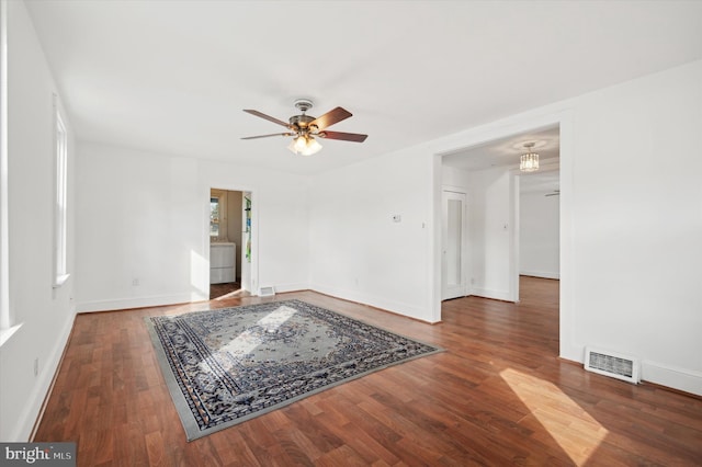 empty room with ceiling fan and dark wood-type flooring