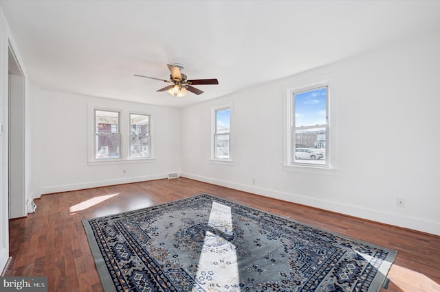 spare room with ceiling fan and dark hardwood / wood-style flooring