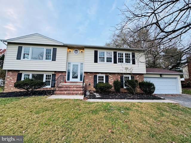 raised ranch with a front yard and a garage