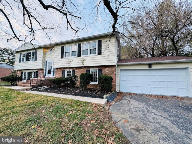 view of front of house featuring a garage and a front lawn