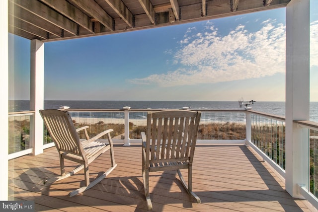 wooden deck featuring a water view