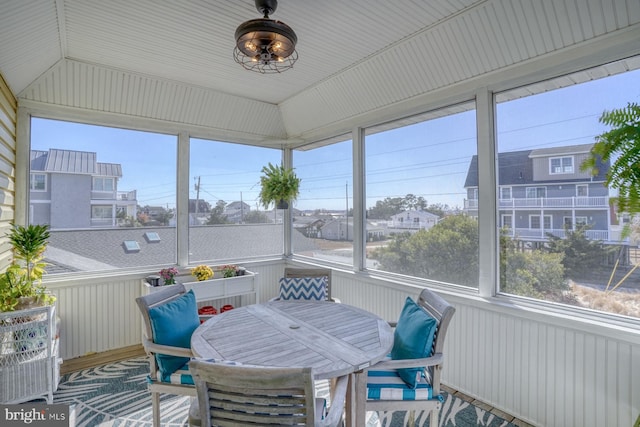 sunroom featuring plenty of natural light and lofted ceiling