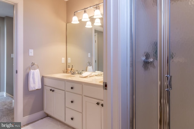 bathroom featuring vanity and a shower with shower door