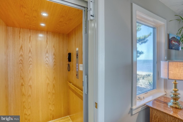 hall featuring wooden ceiling and elevator