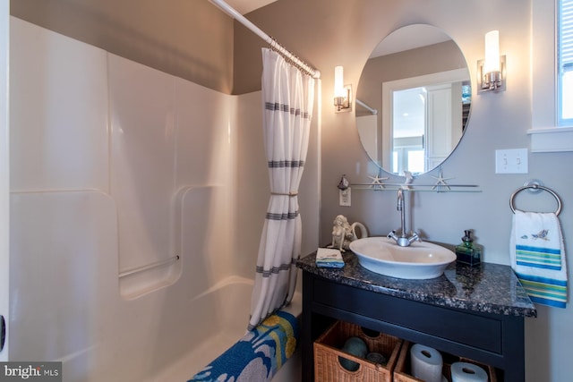 bathroom featuring shower / bath combination with curtain and vanity