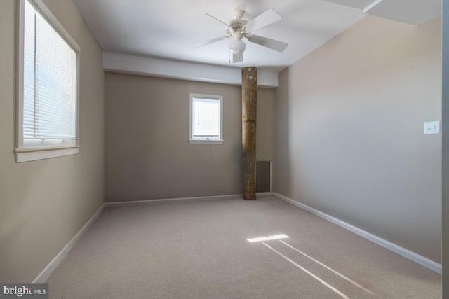 carpeted spare room featuring ceiling fan