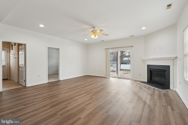 unfurnished living room with hardwood / wood-style floors and ceiling fan