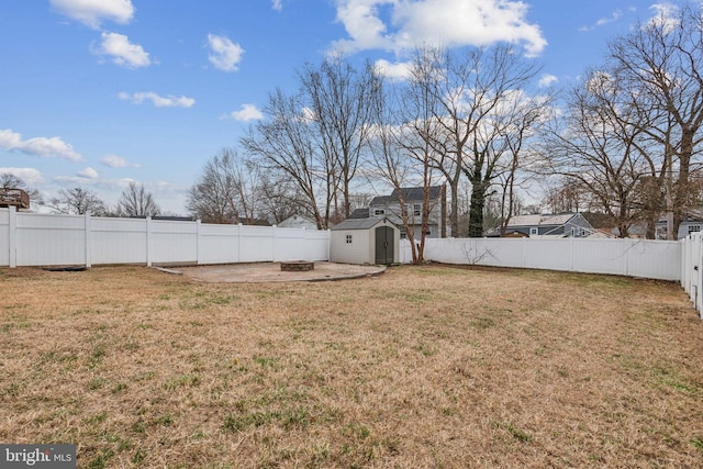 view of yard featuring a storage unit and an outdoor fire pit