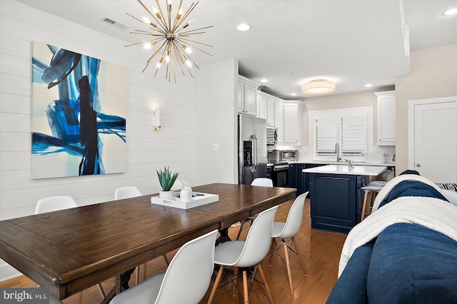 kitchen featuring a kitchen breakfast bar, white cabinets, dark hardwood / wood-style flooring, a kitchen island, and appliances with stainless steel finishes