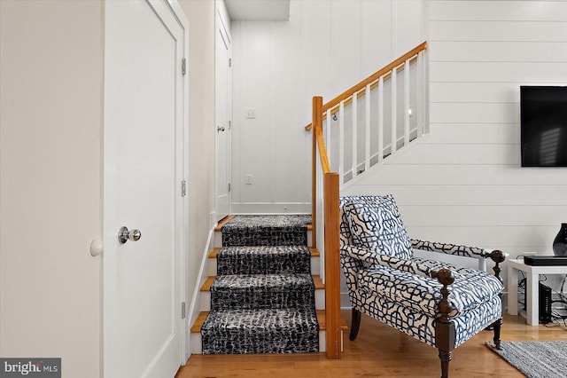 stairs featuring hardwood / wood-style flooring