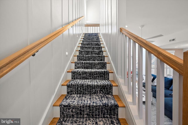 stairs with hardwood / wood-style flooring