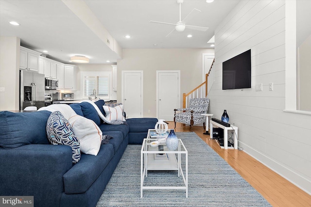 living room with hardwood / wood-style floors and ceiling fan