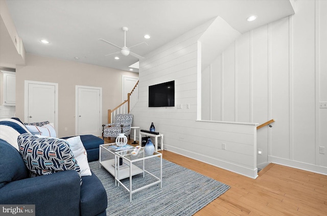 living room featuring ceiling fan and light hardwood / wood-style floors