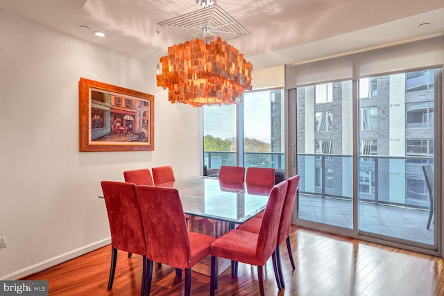 dining room featuring hardwood / wood-style floors and a notable chandelier