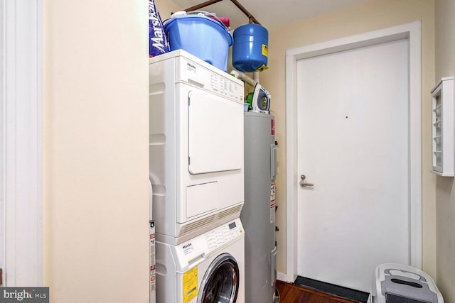 washroom featuring stacked washer and clothes dryer and electric water heater