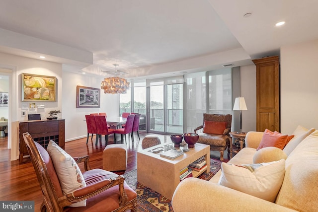 living room featuring dark hardwood / wood-style flooring and a notable chandelier