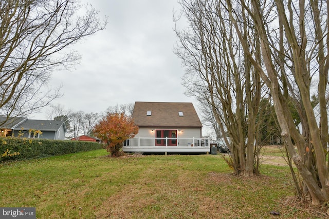 rear view of house with a yard and a deck