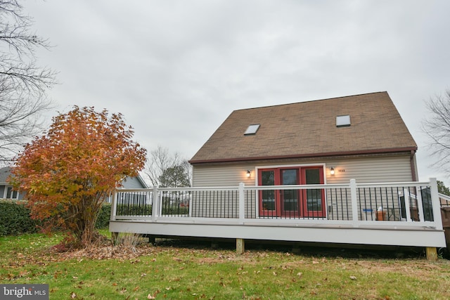 rear view of house with a yard and a wooden deck