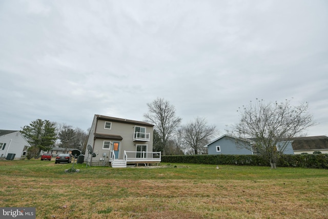 view of front facade with a front yard and a deck