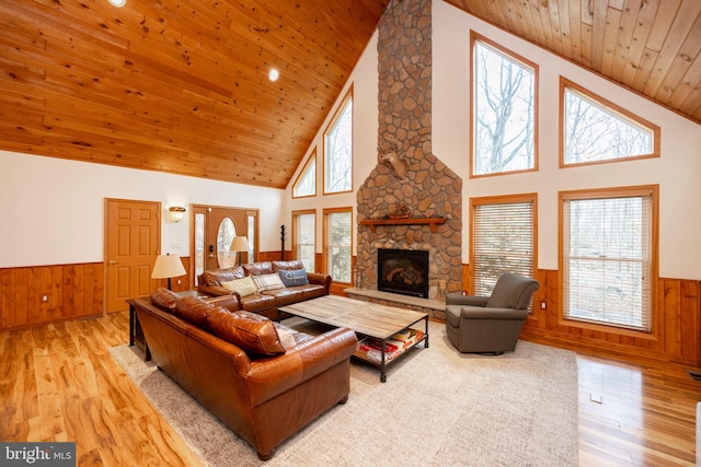 living room with high vaulted ceiling, light hardwood / wood-style flooring, and a wealth of natural light