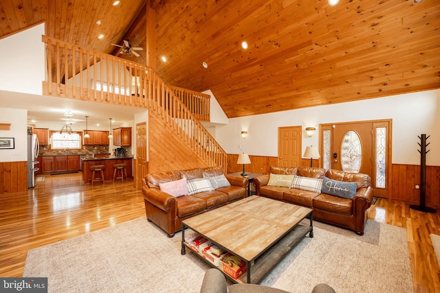 living room featuring light wood-type flooring, ceiling fan, sink, high vaulted ceiling, and wooden ceiling