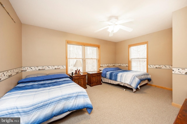 bedroom featuring carpet, multiple windows, and ceiling fan